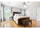 Spacious main bedroom with hardwood floors, large windows, and neutral decor at 7 Wythebrook Ln, Durham, NC 27713