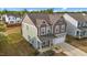 Two-story home with attached garage, well-kept lawn, and screened in porch perfect for entertaining at 7205 Tillage Rd, Mebane, NC 27302