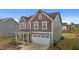 Charming two-story home with attached two-car garage and a lovely front lawn at 7205 Tillage Rd, Mebane, NC 27302