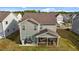 Back of house, featuring screened in porch and patio with grill at 7205 Tillage Rd, Mebane, NC 27302