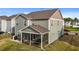 Rear exterior showcasing a screened-in patio and neat yard at 7205 Tillage Rd, Mebane, NC 27302