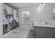 Bright bathroom featuring a double sink vanity, neutral walls and tile floor, and a shower-tub combination at 7205 Tillage Rd, Mebane, NC 27302