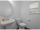 Clean half bathroom featuring a pedestal sink, white fixtures, and natural lighting at 7205 Tillage Rd, Mebane, NC 27302