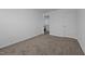 This bedroom features neutral walls and carpeting, and has a closet at 7205 Tillage Rd, Mebane, NC 27302