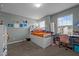 Bedroom featuring a plush carpet, neutral walls, and natural light from two windows and a small desk area at 7205 Tillage Rd, Mebane, NC 27302