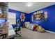 Bedroom with blue painted walls, featuring anime wall art, a black gaming chair, and neutral carpet at 7205 Tillage Rd, Mebane, NC 27302