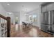 Sunlit dining area showing the stairs to the second floor and modern appliances at 7205 Tillage Rd, Mebane, NC 27302