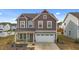 Charming two-story home featuring a 2-car garage and meticulously maintained landscaping at 7205 Tillage Rd, Mebane, NC 27302