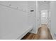 Hallway featuring a built-in bench, coat hooks and light hardwood flooring at 7205 Tillage Rd, Mebane, NC 27302