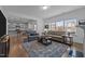 Inviting living room open to kitchen, featuring hardwood flooring and ample natural light at 7205 Tillage Rd, Mebane, NC 27302