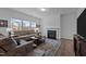 Comfortable living room with a fireplace, plush seating, natural light and hardwood flooring at 7205 Tillage Rd, Mebane, NC 27302