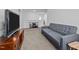 Comfortable living room featuring a carpet flooring, a sofa, and a TV stand at 7205 Tillage Rd, Mebane, NC 27302