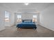 Spacious main bedroom featuring neutral walls and carpet, trey ceiling, and natural light from three windows at 7205 Tillage Rd, Mebane, NC 27302