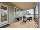 Relax on the screened in porch with comfortable seating and views of the backyard at 7205 Tillage Rd, Mebane, NC 27302