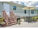Backyard patio area with a grill, umbrella, and seating for outdoor entertaining at 7228 Lowery Meadow Dr, Wendell, NC 27591