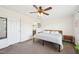 Cozy bedroom features neutral walls and carpet, ceiling fan, and a door leading to an ensuite bathroom at 7228 Lowery Meadow Dr, Wendell, NC 27591