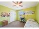 A bedroom with green walls, a desk, ceiling fan and window to the outside at 7228 Lowery Meadow Dr, Wendell, NC 27591