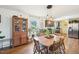 Dining area features a wooden table set, vintage cabinet, and ample natural light from a large window at 7228 Lowery Meadow Dr, Wendell, NC 27591