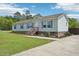 Single-story home featuring a landscaped yard, concrete driveway, and welcoming entryway at 7228 Lowery Meadow Dr, Wendell, NC 27591