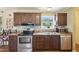 Modern kitchen features stainless steel appliances, wood cabinets, and plenty of counter space for meal preparation at 7228 Lowery Meadow Dr, Wendell, NC 27591