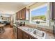 Kitchen features stainless steel appliances, wood cabinets, and a large window above the sink with backyard view at 7228 Lowery Meadow Dr, Wendell, NC 27591