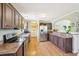 Spacious kitchen with wood cabinets, stainless steel appliances, and view into the laundry and dining area at 7228 Lowery Meadow Dr, Wendell, NC 27591