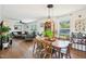 Bright living room boasts wood floors, comfortable seating, and plenty of natural light from large windows at 7228 Lowery Meadow Dr, Wendell, NC 27591