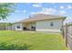 Expansive backyard featuring a covered patio, barbecue grill, and lush green lawn, perfect for entertainment and relaxation at 8 Pal Ct, Benson, NC 27504