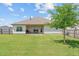Well-maintained backyard featuring a covered patio, grill, and lush green lawn perfect for outdoor activities at 8 Pal Ct, Benson, NC 27504