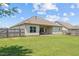 Spacious backyard with a fenced perimeter, complemented by a covered patio, and a well-manicured lawn at 8 Pal Ct, Benson, NC 27504