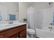 Bathroom with a shower and bathtub combination, white vanity top, and cherry wood cabinets at 8 Pal Ct, Benson, NC 27504