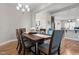 Dining room with modern furnishings, hardwood floors, and views to the kitchen at 8 Pal Ct, Benson, NC 27504