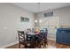 Dining room featuring hardwood floors, modern lighting, and a large window at 8 Pal Ct, Benson, NC 27504