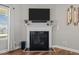 A close up view of the marble fireplace, mantle, television and hardwood flooring at 8 Pal Ct, Benson, NC 27504