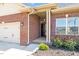 A view of the front entry and rose garden of this attractive red brick home at 8 Pal Ct, Benson, NC 27504
