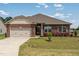 Charming brick home featuring manicured landscaping and a convenient two-car garage at 8 Pal Ct, Benson, NC 27504