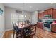 Eat-in kitchen featuring stainless steel appliances, wooden cabinets, and a wooden dining table at 8 Pal Ct, Benson, NC 27504