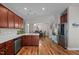 Open concept kitchen with stainless steel appliances, quartz countertops, and views to dining area at 8 Pal Ct, Benson, NC 27504