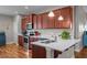 Kitchen featuring wooden cabinets, modern appliances, white countertop, and hardwood floors at 8 Pal Ct, Benson, NC 27504