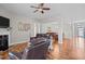 Open-concept living room with hardwood floors, ceiling fan and comfortable seating arrangement at 8 Pal Ct, Benson, NC 27504