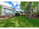 Spacious backyard with lush lawn, mature trees, and a wooden deck for outdoor entertaining at 8005 Somerdale Dr, Durham, NC 27713