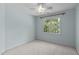 Neutral bedroom with carpet, large window with backyard views, and ceiling fan with light at 8005 Somerdale Dr, Durham, NC 27713