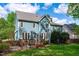 Charming blue two-story home with a wooden deck and a well-maintained lawn at 8005 Somerdale Dr, Durham, NC 27713
