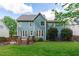 Charming blue two-story home featuring a wooden deck and a well-manicured lawn at 8005 Somerdale Dr, Durham, NC 27713