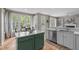 Eat-in kitchen with a green center island, stainless steel appliances, and lots of natural light at 8005 Somerdale Dr, Durham, NC 27713