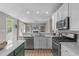Modern kitchen with stainless steel appliances, an island and an open view to the living room at 8005 Somerdale Dr, Durham, NC 27713