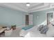 Spacious main bedroom featuring tray ceiling, soft blue walls, carpet, a queen size bed and large doorway at 8005 Somerdale Dr, Durham, NC 27713
