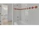 Bathroom with a white tub and shower featuring red diamond-patterned tile at 8022 Hogan Dr, Wake Forest, NC 27587