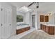 Bright bathroom with a soaking tub, separate shower, and a skylight for natural illumination at 8022 Hogan Dr, Wake Forest, NC 27587