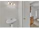 Small secondary bathroom featuring a pedestal sink and three sconce lighting at 8022 Hogan Dr, Wake Forest, NC 27587